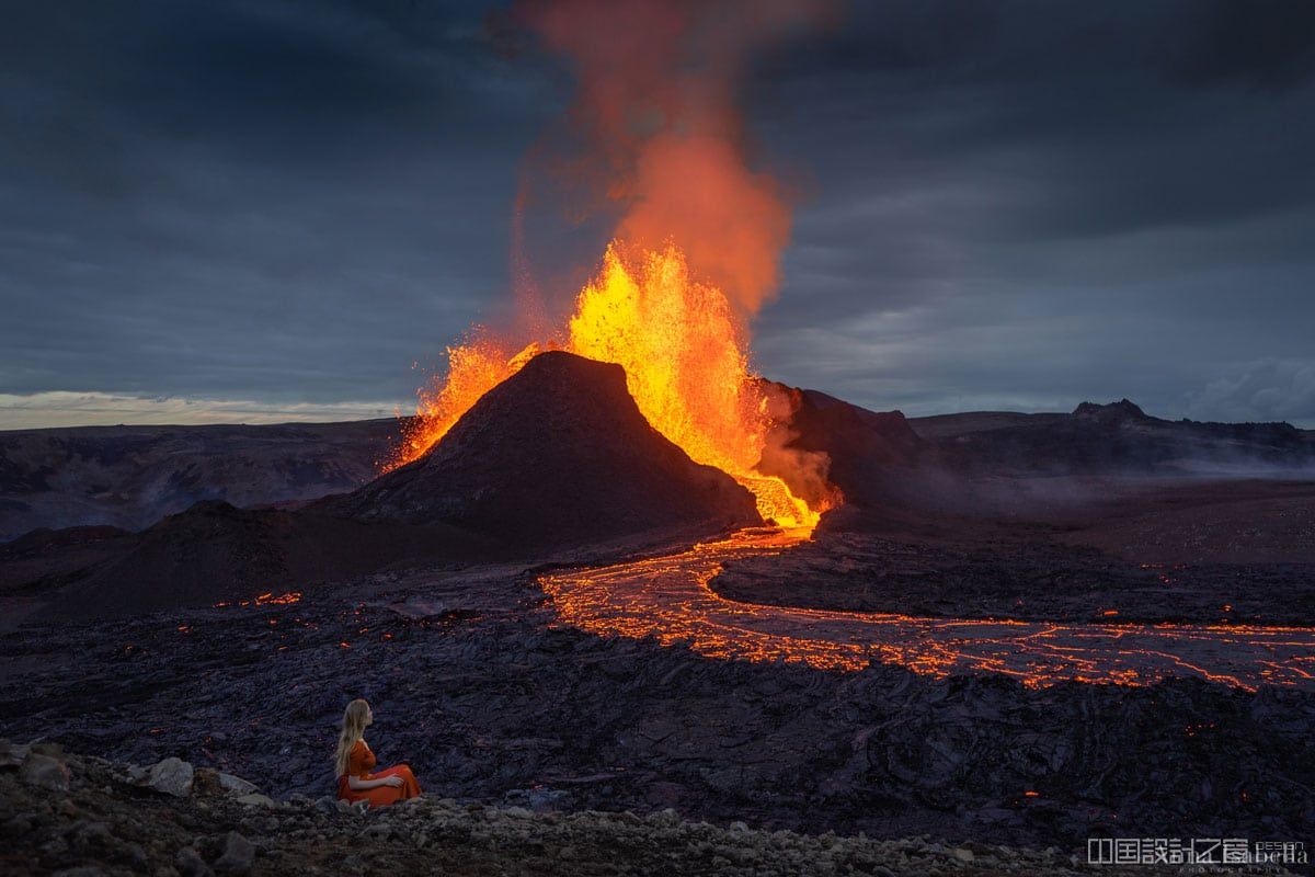 Fagradalsfjall Volcano Erupting with Woman Seated in the Foreground
