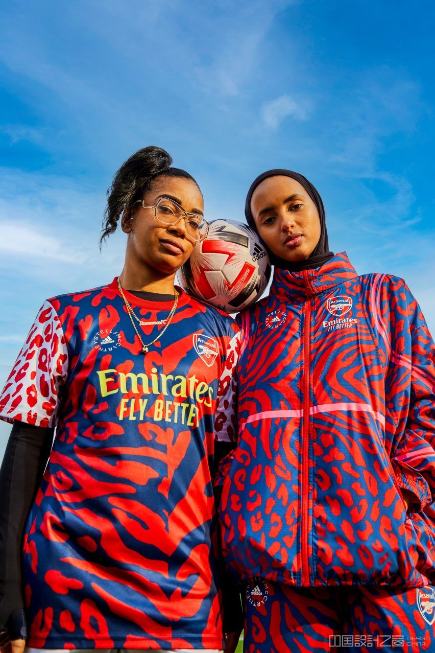 Two women wearing red and blue sportswear