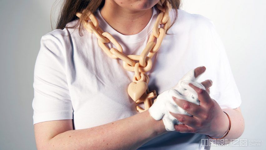 Figure wearing chunky necklace while washing their hands