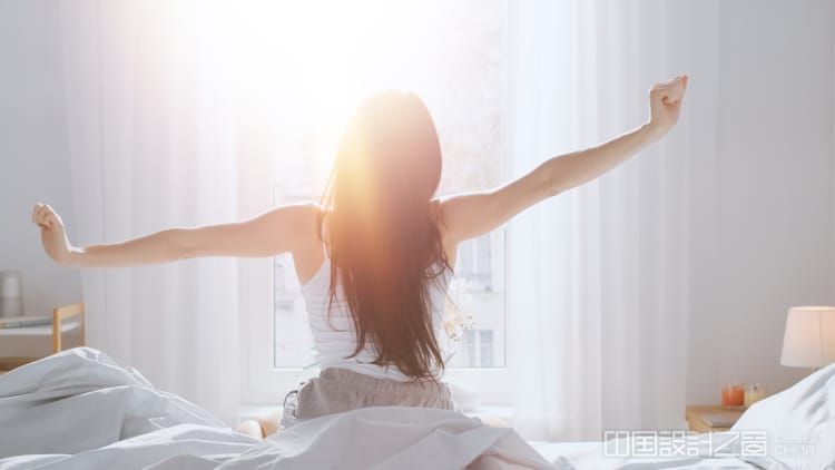 Woman Stretching Her Arms in Bed