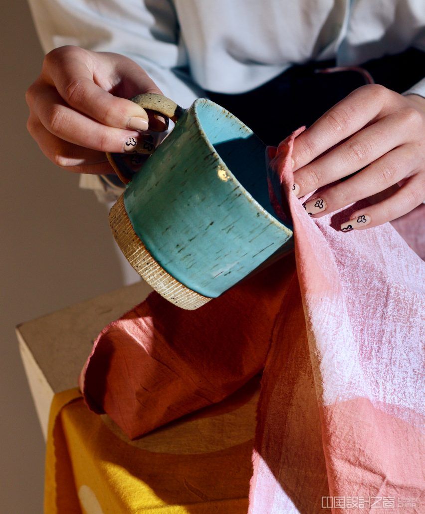 Figure using fabric to dry a mug