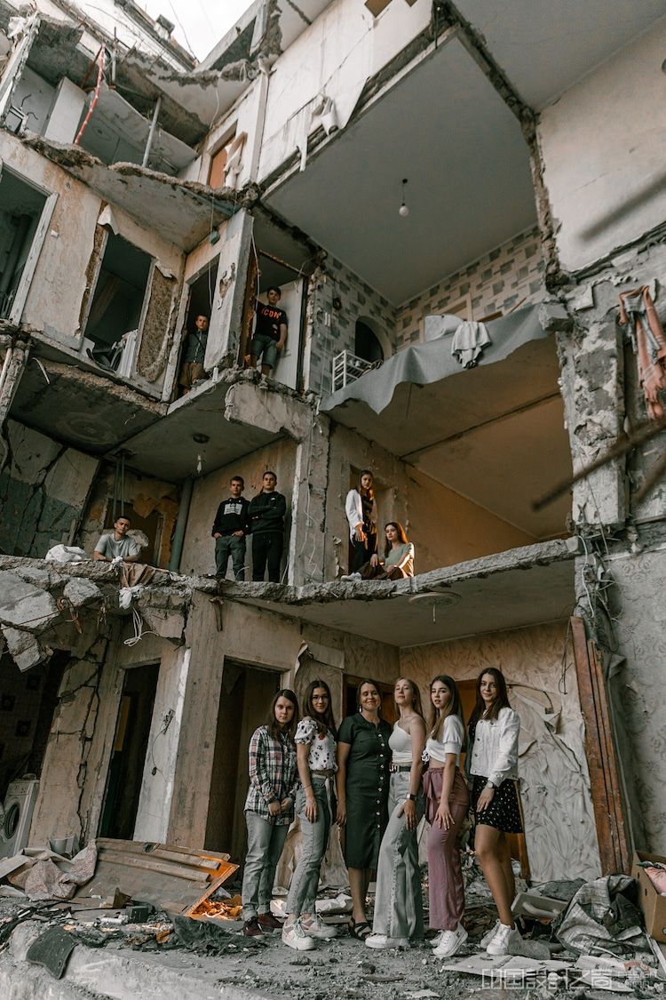 Ukrainian Students Standing in Rubble of their School by Stanislav Senyk