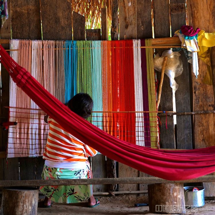 Guajajara woman in Brazil weaving a maniá hammock