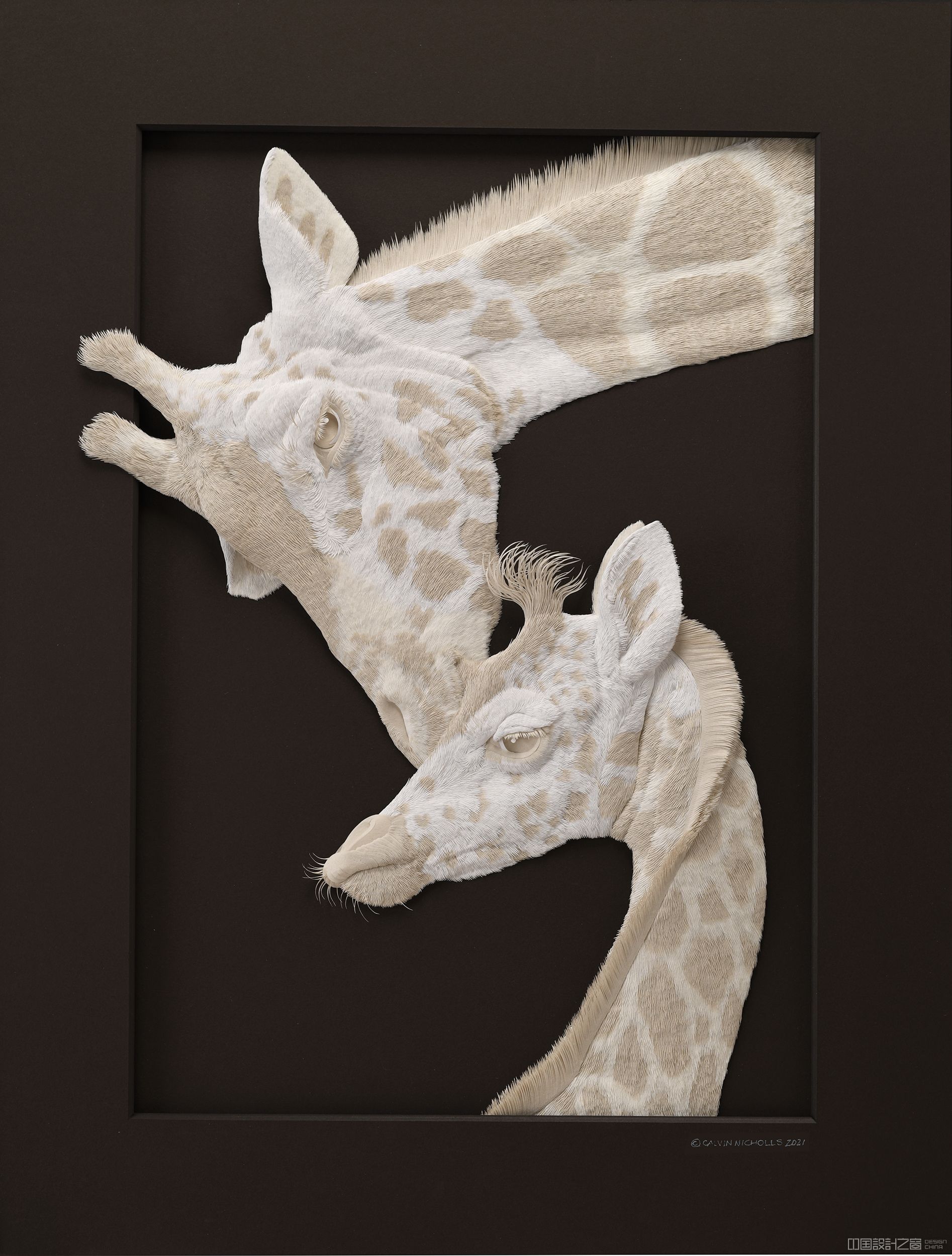 A sculpture of two giraffes made from paper.